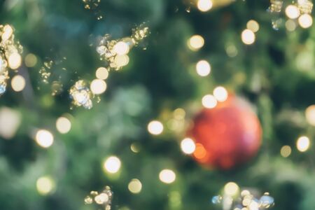 Abstract christmas holiday with festive gold bokeh light on tree blurred backgroundの写真素材