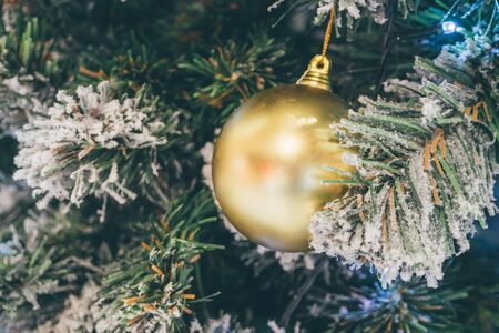 Decorated Christmas ball on fir tree New Year holidays backgroundの写真素材