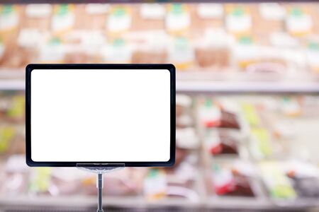 Mock up blank price board poster sign display with Abstract fresh meat shelves in supermarket grocery store blurred defocused background with bokeh lightの写真素材