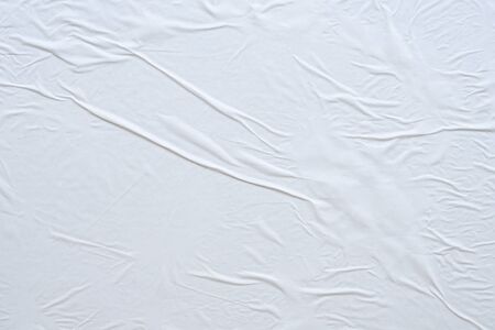 Blank white crumpled and creased paper poster texture backgroundの写真素材