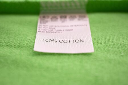 White laundry care washing instructions clothes label on cotton shirtの写真素材