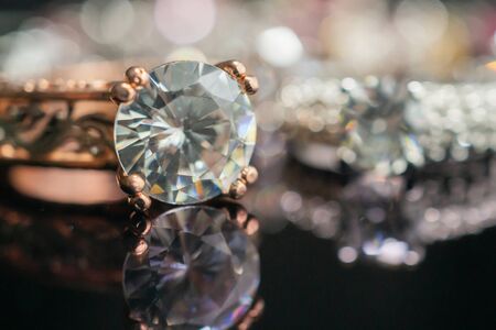 Jewelry wedding diamond rings on black background with reflection