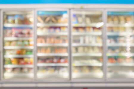 supermarket commercial refrigerators freezer showing frozen foods abstract blur backgroundの写真素材