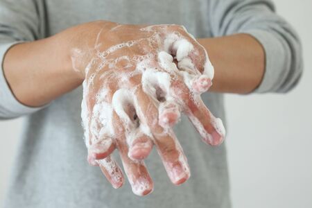 Man wash hands with soap for COVID-19 corona virus prevention conceptの写真素材