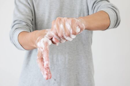 Man wash hands with soap for COVID-19 corona virus prevention conceptの写真素材