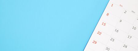 calendar page close up on blue background business planning appointment meeting conceptの写真素材