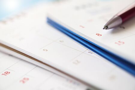 calendar page with pen close up background business planning appointment meeting conceptの写真素材