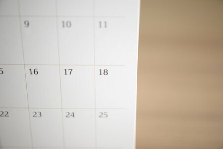 calendar page close up on wood table background business planning appointment meeting conceptの写真素材