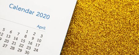 Happy new year 2020 calendar page close up on gold glitter sparkle backgroundの写真素材