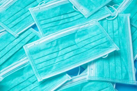 Blue surgical face mask texture background protection against air pollution and COVID-19 coronavirus. Healthcare and medical conceptの写真素材