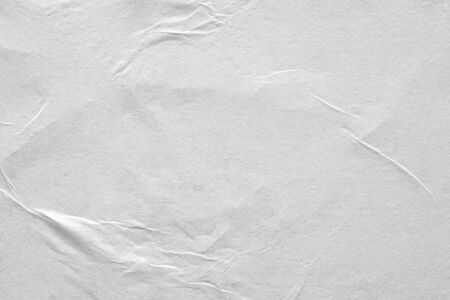 Blank white crumpled and creased paper poster texture backgroundの写真素材