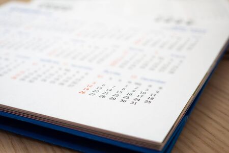 Close up calendar page dates abstract blurred background business planning appointment meeting...
