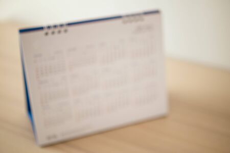 Blur calendar page close up on wood table background business planning appointment meeting conceptの写真素材