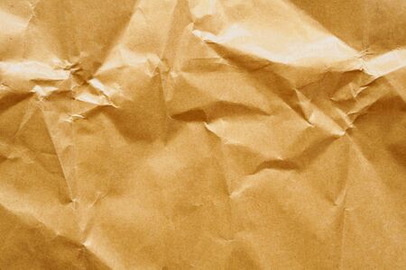 Brown crumpled paper recycled kraft sheet texture backgroundの写真素材