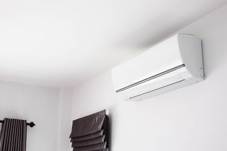 Air conditioner on white wall room interior backgroundの写真素材