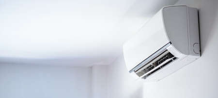 Air conditioner on white wall room interior backgroundの写真素材