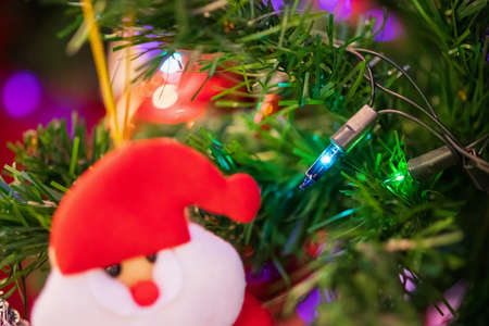 Decorated Christmas light on fir tree New Year holidays backgroundの写真素材