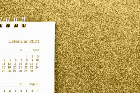 Happy new year 2021 calendar page close up on gold glitter sparkle backgroundの写真素材