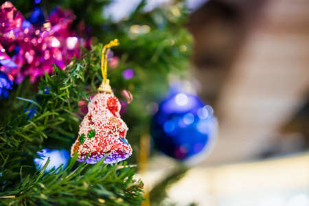 Decorated Christmas baubles on fir tree New Year holidays background