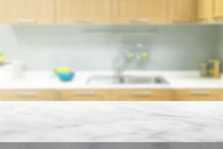 white marble stone counter top with blurred kitchen backgroundの写真素材