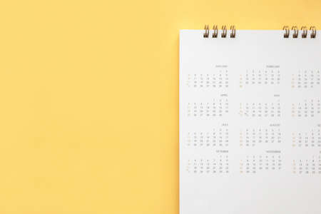 calendar page on yellow color background business planning appointment meeting conceptの写真素材
