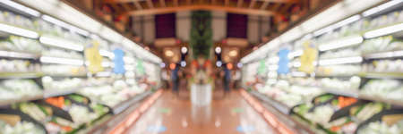 Grocery store shelves with fruits and vegetables blurred backgroundの写真素材