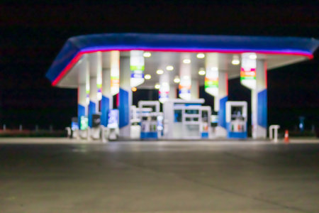 Petrol gas station at night time blurred background with bokeh lightの写真素材