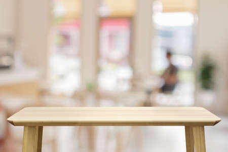 Empty wood table top with cafe restaurant interior blur backgroundの写真素材