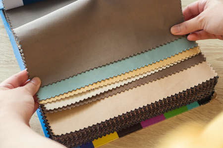 female designer with fabric color samples choosing textile for curtains