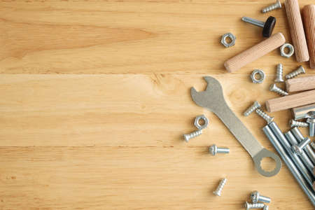 Assembly furniture tool kit with screw dowel wrench and bolt on wood table
