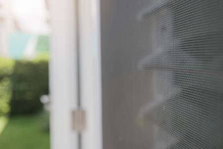 Mosquito net wire screen on house window protection against insectの写真素材