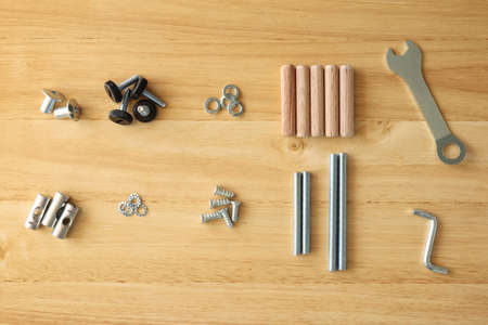Assembly furniture tool kit with screw dowel wrench and bolt on wood table