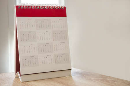 Calendar page close up with white wall background business planning appointment meeting conceptの写真素材