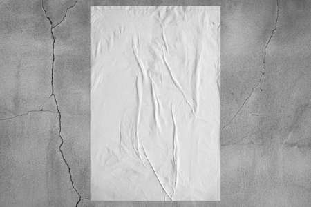 Blank white wheatpaste glued paper poster mockup on concrete wall backgroundの写真素材