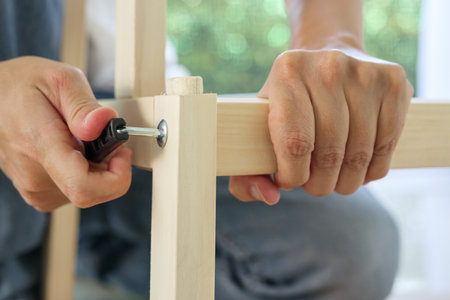 Assembly wooden furniture at home using screw allenの写真素材