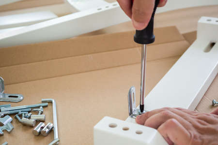 Assembly furniture using screwdriver at homeの写真素材