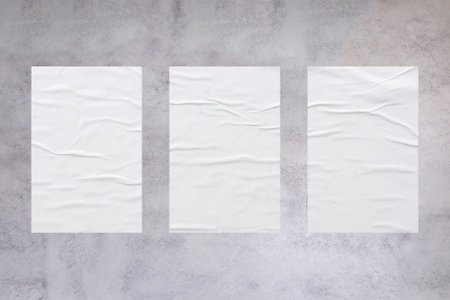 Blank white wheatpaste glued paper poster mockup on concrete wall backgroundの写真素材