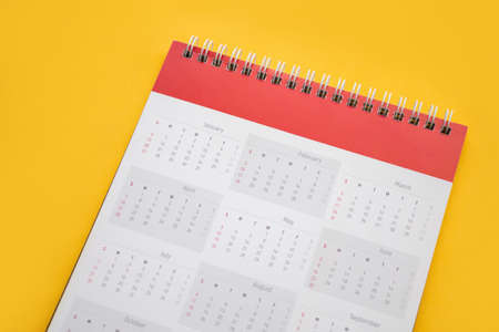 calendar page on yellow background business planning appointment meeting conceptの写真素材