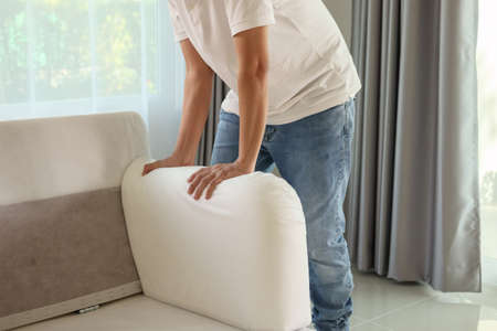 Man assembling sofa furniture at homeの写真素材