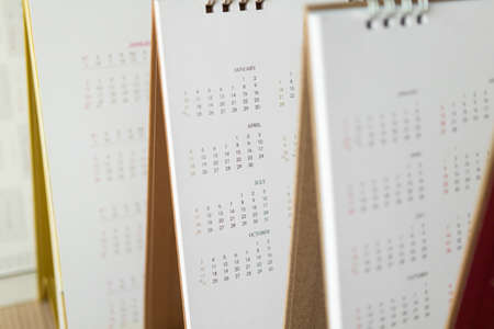 Close up calendar page dates and month background business planning appointment meeting concept