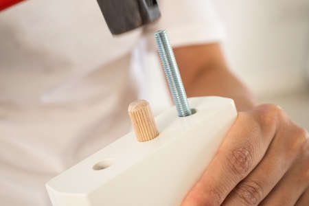 Man assembling furniture at homeの写真素材