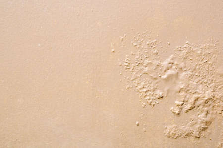 Brown wall damp damaged with peeling paint