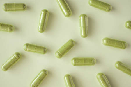 Herbal medicine capsules on white backgroundの写真素材