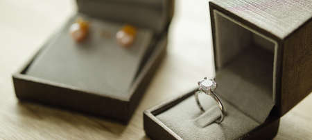 Diamond ring in jewelry gift box on wood tableの写真素材