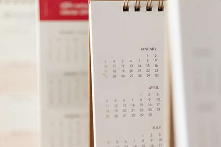Close up calendar page dates and month background business planning appointment meeting concept