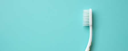 Toothbrush on blue background top view close upの写真素材