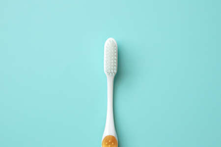 Toothbrush on blue background top view close upの写真素材