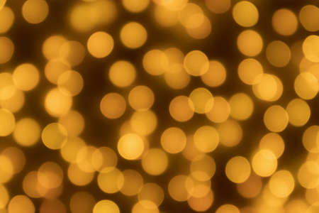Abstract blur golden bokeh light Christmas holiday backgroundの写真素材