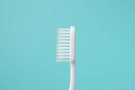 Toothbrush on blue background top view close upの写真素材