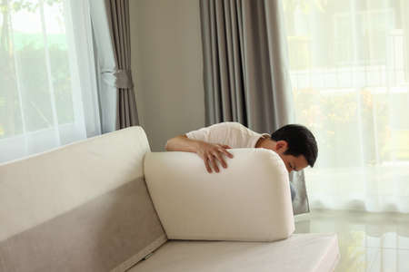 Man assembling sofa furniture at homeの写真素材